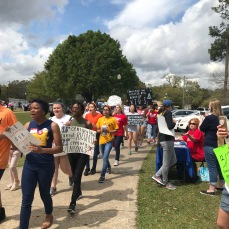 Student marchers with signs at the March for Our Lives in Mobile AL